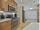 Modern kitchen featuring stainless steel appliances, light wood cabinets, and white countertops at 308 Summer Pl, Peachtree City, GA 30269