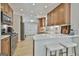 Spacious kitchen featuring wooden cabinets, stainless steel appliances, and a breakfast bar at 308 Summer Pl, Peachtree City, GA 30269