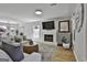Bright living room featuring a fireplace, ample seating, and neutral decor at 308 Summer Pl, Peachtree City, GA 30269
