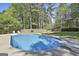 Sparkling in-ground pool with diving board and surrounding concrete deck offers an inviting backyard oasis at 308 Summer Pl, Peachtree City, GA 30269