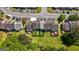 Townhomes with green space and back patios line a parking area in this aerial view at 5882 Trent Walk Dr, Lithonia, GA 30038