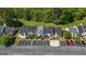 Aerial view shows well-maintained townhomes with parking, landscaping, and a grassy common area at 5882 Trent Walk Dr, Lithonia, GA 30038