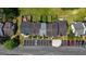Aerial view shows the roofs and backyard patios of well-maintained townhomes and parking at 5882 Trent Walk Dr, Lithonia, GA 30038