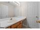 Bathroom with an extended vanity, a large mirror, and a bright lighting fixture at 5882 Trent Walk Dr, Lithonia, GA 30038