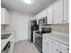 Kitchen with white cabinets, black appliances, and updated countertops at 5882 Trent Walk Dr, Lithonia, GA 30038