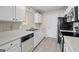Functional kitchen layout, white cabinets and updated appliances and countertops at 5882 Trent Walk Dr, Lithonia, GA 30038