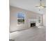 Cozy living room featuring a marble fireplace and two large, bright windows at 5882 Trent Walk Dr, Lithonia, GA 30038