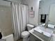 Cozy bathroom with a tub/shower combo and a modern vessel sink atop a granite countertop at 403 Rock Creek Dr, Peachtree City, GA 30269