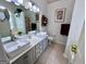 Bright bathroom features double vessel sinks, modern fixtures, ample counter space, and neutral tile flooring at 403 Rock Creek Dr, Peachtree City, GA 30269
