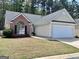 Charming single-story home with a brick facade, attached garage, and well-maintained lawn at 403 Rock Creek Dr, Peachtree City, GA 30269