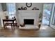 Bright living room fireplace featuring updated mantel and access to backyard at 403 Rock Creek Dr, Peachtree City, GA 30269