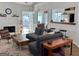Bright living room with a cozy fireplace, modern furnishings, and access to outdoor spaces at 403 Rock Creek Dr, Peachtree City, GA 30269