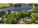 Aerial view showcasing a lake community surrounded by mature trees and lush landscapes at 423 Bear Creek Trl, Hampton, GA 30228