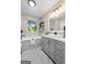 Light and airy bathroom featuring a modern vanity with white countertop and gray cabinets at 423 Bear Creek Trl, Hampton, GA 30228