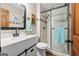 Updated bathroom with a walk-in shower with glass door, vanity and mosaic tile accents at 423 Bear Creek Trl, Hampton, GA 30228