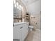 Stylish bathroom featuring a modern vanity, elegant mirror, and decorative shelving for an organized and inviting space at 423 Bear Creek Trl, Hampton, GA 30228