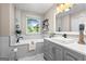 Bright bathroom showcasing a bathtub with gray tile surround and a stylish gray vanity at 423 Bear Creek Trl, Hampton, GA 30228