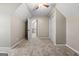 Inviting bedroom featuring neutral tones, a ceiling fan, and a view into the hallway for an open and airy feel at 423 Bear Creek Trl, Hampton, GA 30228