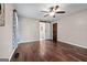 Bedroom with barn-style door, hardwood floors, and view of adjacent bathroom at 423 Bear Creek Trl, Hampton, GA 30228
