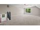 Large, carpeted bonus room with a window offering natural light and a view of the outdoors, perfect for recreation at 423 Bear Creek Trl, Hampton, GA 30228