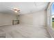 Expansive carpeted bonus room with ample natural light and view, enhanced by neutral walls and a modern ceiling fan at 423 Bear Creek Trl, Hampton, GA 30228