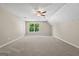 Carpeted bonus room with natural light, a ceiling fan, and neutral walls, offering a versatile space for various activities at 423 Bear Creek Trl, Hampton, GA 30228