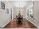 Cozy dining room with hardwood floors, a chandelier, and a view to the kitchen at 423 Bear Creek Trl, Hampton, GA 30228