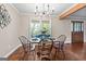 Bright dining room with hardwood floors, natural light, and elegant chandelier at 423 Bear Creek Trl, Hampton, GA 30228