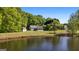 Exterior shot of the home and detached garage with stunning lake views at 423 Bear Creek Trl, Hampton, GA 30228