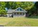 Exterior view of home featuring large windows and a covered patio at 423 Bear Creek Trl, Hampton, GA 30228