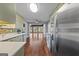 Modern kitchen featuring stainless steel appliances and stylish finishes, leading to the living space at 423 Bear Creek Trl, Hampton, GA 30228