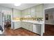 Spacious kitchen features abundant sage cabinetry, stainless appliances and mosaic tile backsplash at 423 Bear Creek Trl, Hampton, GA 30228