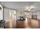 Spacious living room with hardwood floors and comfortable seating, showing kitchen access at 423 Bear Creek Trl, Hampton, GA 30228