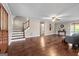 Spacious living room with hardwood floors, stairs, and ample natural light, showcasing an open layout at 423 Bear Creek Trl, Hampton, GA 30228