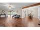Open-concept living and dining area with hardwood floors, neutral walls, and ample natural light at 423 Bear Creek Trl, Hampton, GA 30228