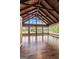 Bright room featuring wood paneling, hardwood floors, vaulted ceilings and floor to ceiling windows at 423 Bear Creek Trl, Hampton, GA 30228
