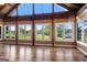 Bright room with wood paneling, vaulted ceiling, and a scenic view of a lake at 423 Bear Creek Trl, Hampton, GA 30228