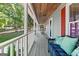 Inviting porch with comfortable seating, rocking chairs, and view of the spacious yard at 423 Bear Creek Trl, Hampton, GA 30228