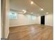 Finished basement area with hardwood floors, white walls, recessed lighting, and bright windows at 2571 Stanford Dr, Ellenwood, GA 30294