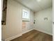 Unfinished basement area with hardwood floors, white walls, one window and utility access at 2571 Stanford Dr, Ellenwood, GA 30294