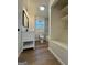 Clean bathroom featuring a white vanity, a toilet, and a window for natural light at 2571 Stanford Dr, Ellenwood, GA 30294