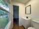 Modern bathroom featuring a stylish vanity, a black framed mirror, and tile flooring at 2571 Stanford Dr, Ellenwood, GA 30294