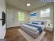 Virtual Staging: Modern bedroom with a cozy bed, white rug, and ample natural light at 2571 Stanford Dr, Ellenwood, GA 30294