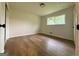 Cozy bedroom with hardwood floors, neutral walls, and a window providing natural light at 2571 Stanford Dr, Ellenwood, GA 30294