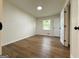 Well-lit bedroom featuring hardwood floors and a view of the outdoors through the window at 2571 Stanford Dr, Ellenwood, GA 30294