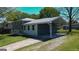 Charming two-story home features a covered carport, gray and white paint scheme, and a well-manicured front lawn at 2571 Stanford Dr, Ellenwood, GA 30294