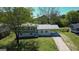 Aerial view of a charming two-story home with a covered carport and well-manicured lawn and mature trees at 2571 Stanford Dr, Ellenwood, GA 30294