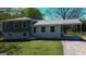 Charming two-story home features a covered carport, gray and white paint scheme, and a well-manicured front lawn at 2571 Stanford Dr, Ellenwood, GA 30294