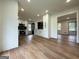 Open-concept kitchen featuring white cabinets, stainless steel appliances, and light wood flooring at 2571 Stanford Dr, Ellenwood, GA 30294