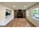 Spacious living room features a modern fireplace, wood floors, and abundant natural light, creating a welcoming atmosphere at 2571 Stanford Dr, Ellenwood, GA 30294
